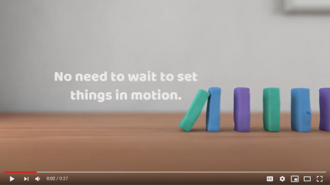 Core banking automation trigger video still with domino pieces and text saying "No need to wait to set things in motion"